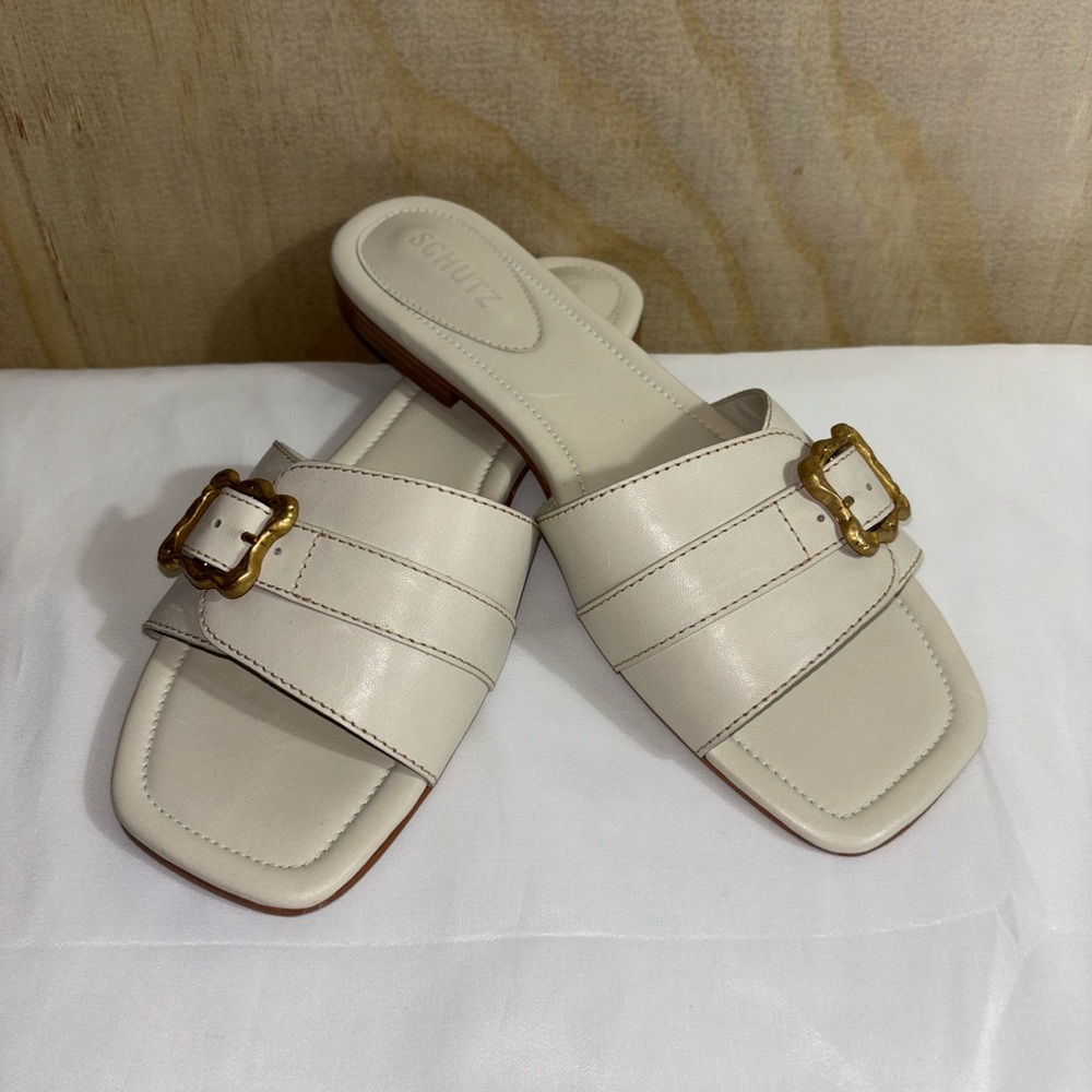 SCHUTZ Cream Slide Sandals with Gold Buckle